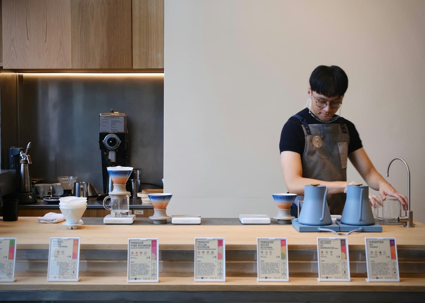 Barista preparing coffee behind a counter