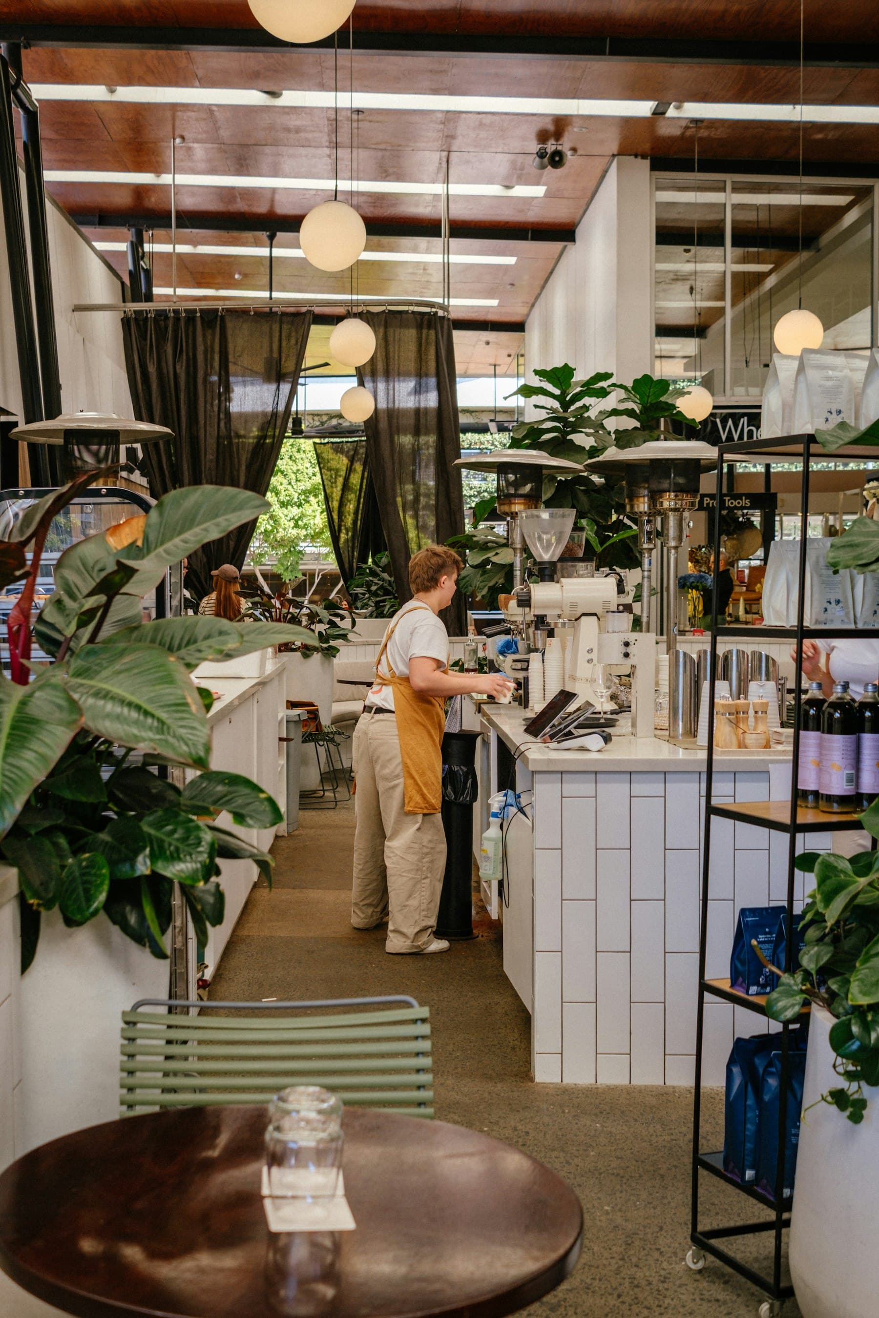 A barista working at a modern cafe counter